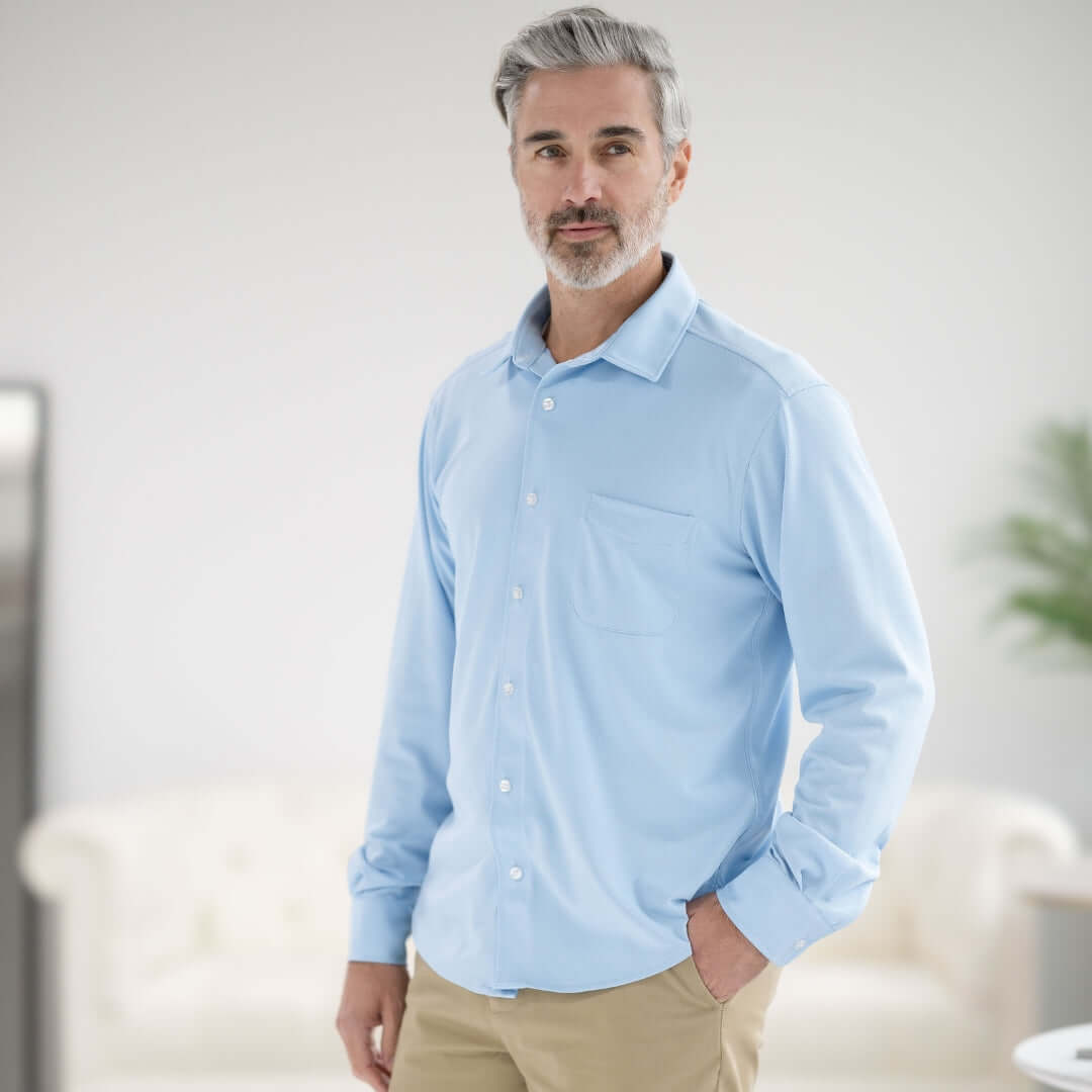 Man wearing a Carolina Blue long sleeve magnetic button shirt with pocket, showcasing comfort and style.