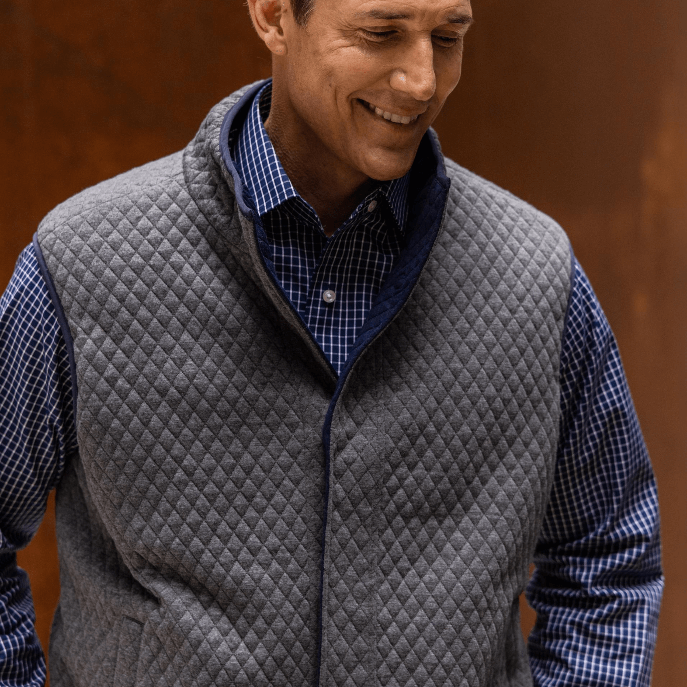 Man wearing the MagnaReady® Reversible Diamond Quilted Magnetic Button Vest in charcoal, showcasing adaptive comfort.
