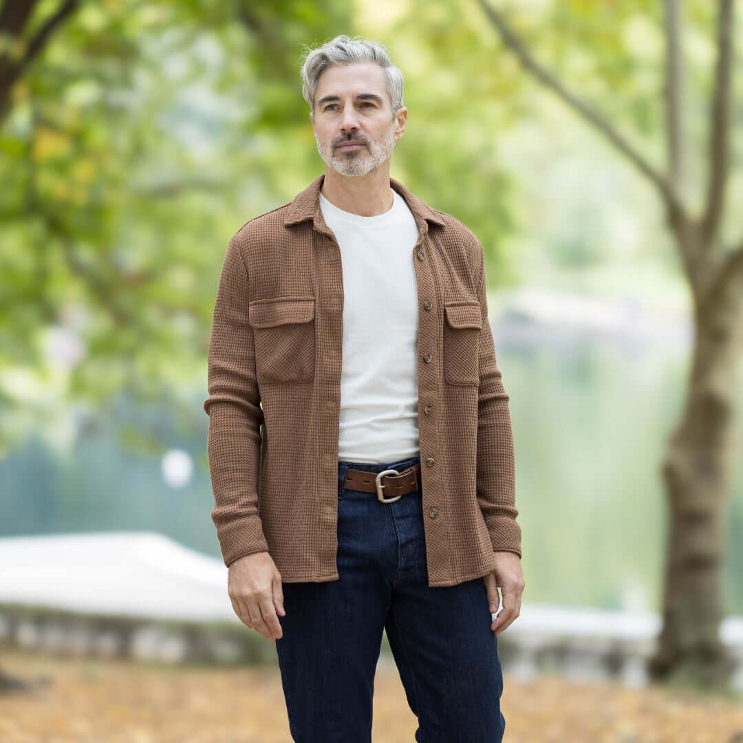Man wearing a Magnetic Front WaffleWeave Casual Shirt in Choco with dual pockets, set in a serene outdoor environment.