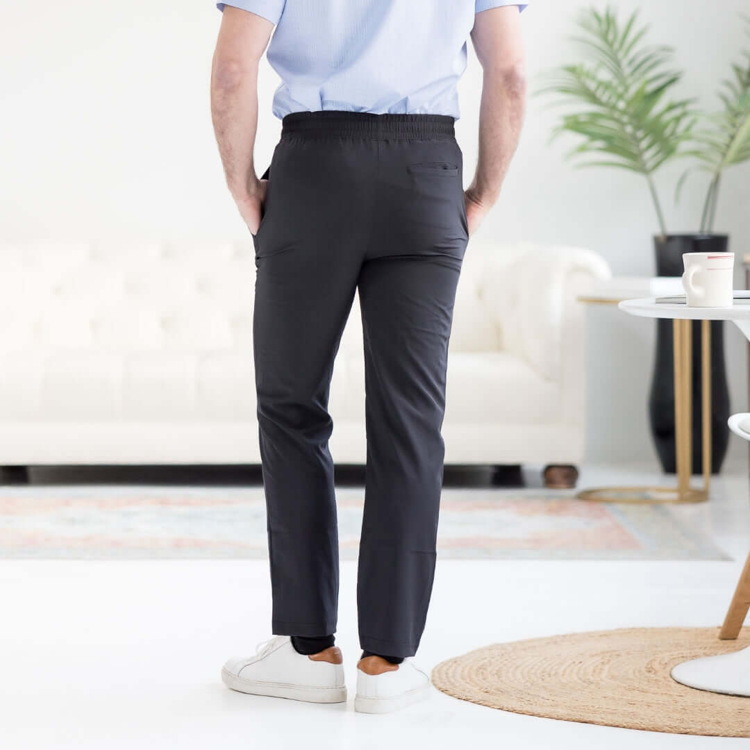 Men's adaptive elastic waist track pants in black, showcasing a sleek back view, ideal for versatility and comfort.