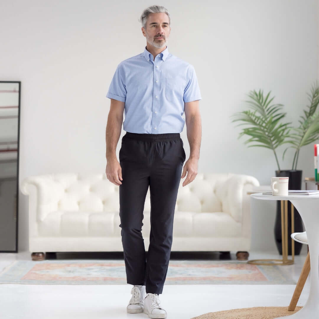 Men's adaptive elastic waist track pants in black, styled with a short-sleeve shirt, perfect for casual and active wear.