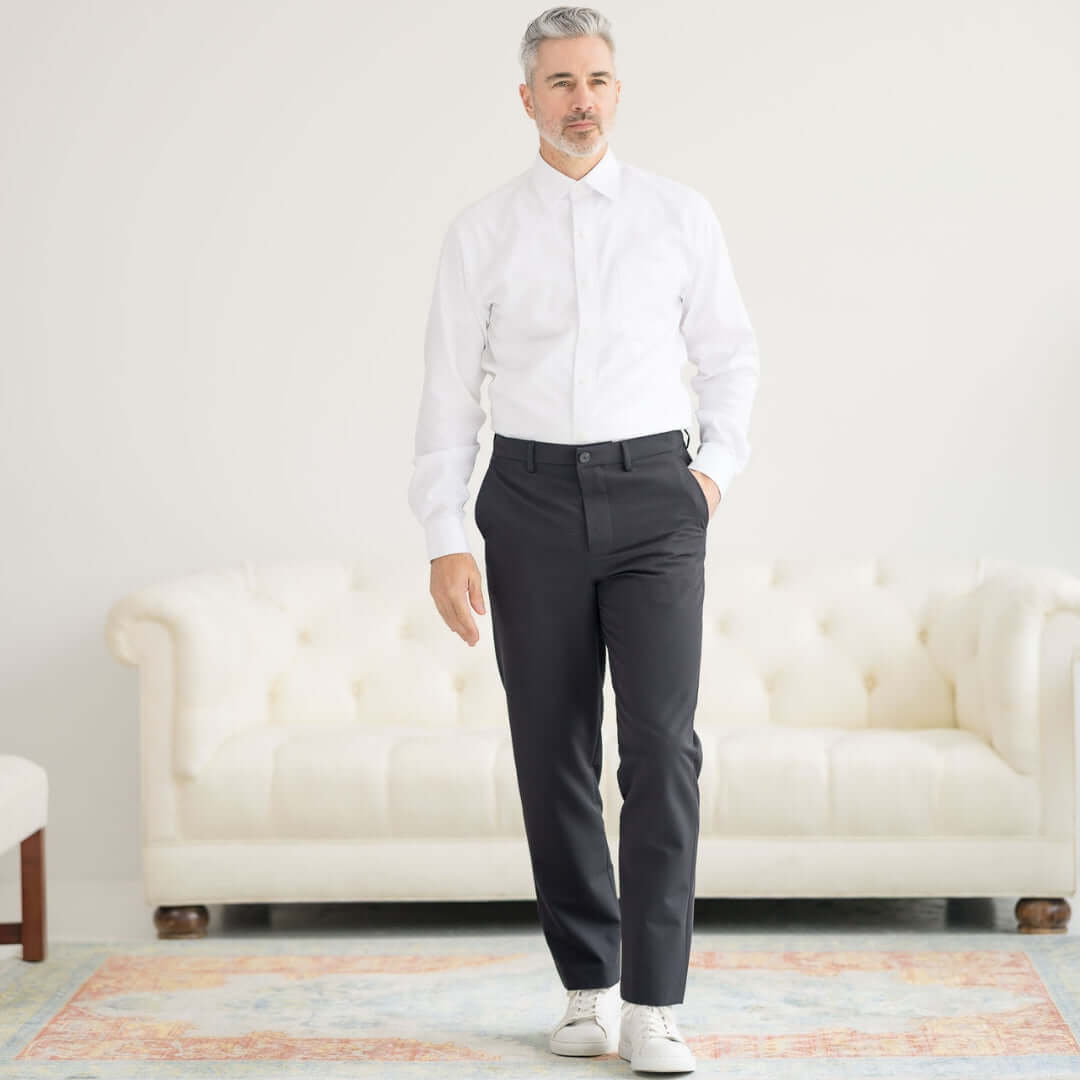 Man wearing Nautica® x MagnaReady® Adaptive Fly Stretch Dress Pant in Black with a white shirt and stylish sneakers.