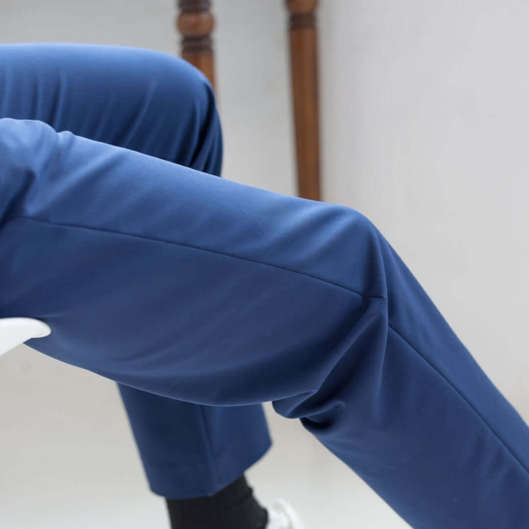 Close-up of a man's navy adaptive dress pants from Nautica® x MagnaReady®, showcasing modern stretch fit design.