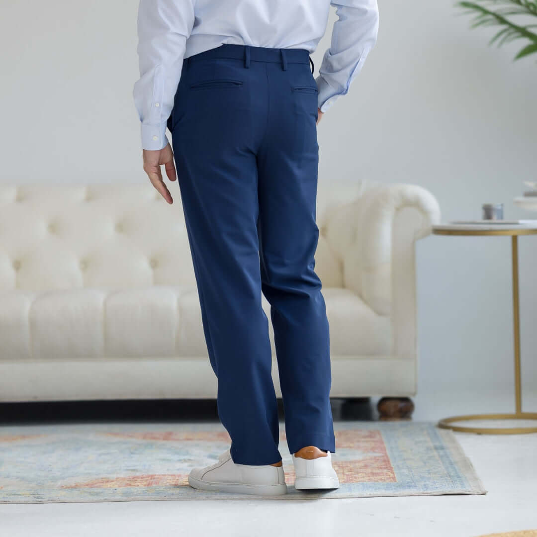 Back view of modern Navy dress pants from Nautica® x MagnaReady® on a man, showcasing adaptive fit and style.