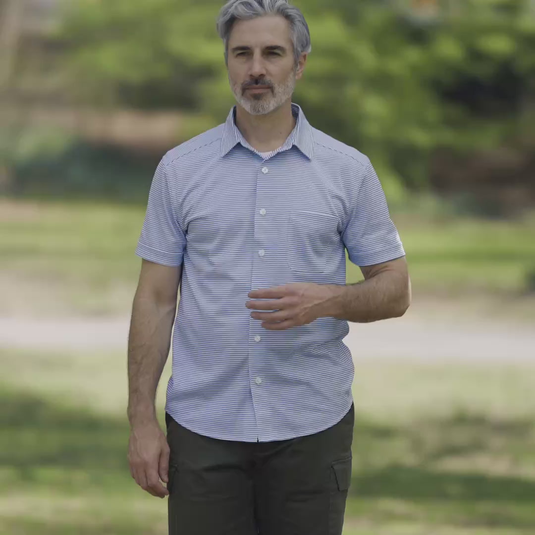 Adaptive Cooling Magnetic Front Short Sleeve Shirt in Green Stripe modeled by a man outdoors.