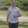 Adaptive Cooling Magnetic Front Short Sleeve Shirt in Green Stripe modeled by a man outdoors.