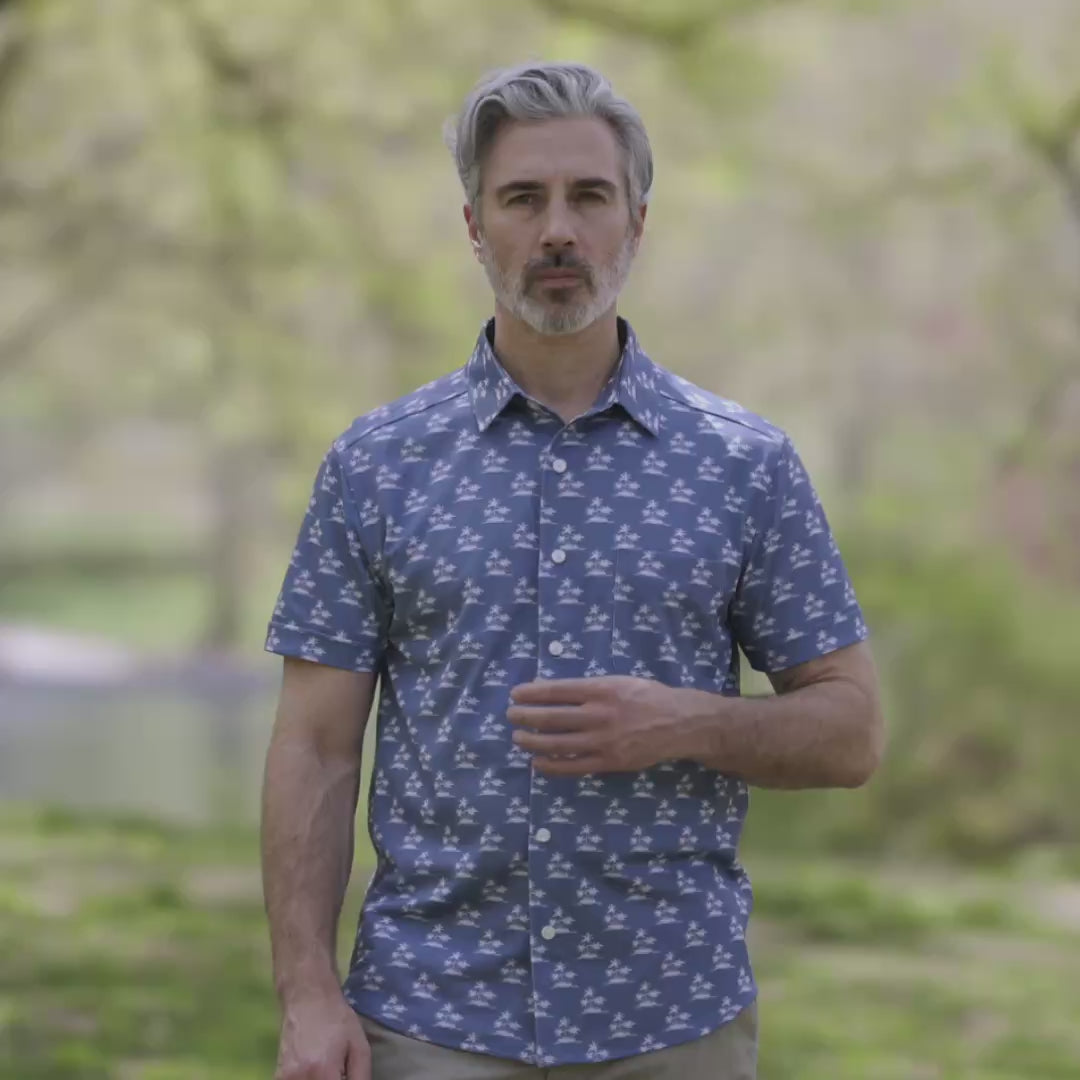 Adaptive Cooling Magnetic Front Short Sleeve Shirt in Blue Palm worn by a man outdoors in a natural setting.