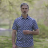 Adaptive Cooling Magnetic Front Short Sleeve Shirt in Blue Palm worn by a man outdoors in a natural setting.