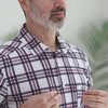 Man wearing an adaptive cooling magnetic short sleeves shirt with plaid design, demonstrating comfort and style.