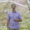 Adaptive Cooling Magnetic Front Short Sleeve Shirt in Pink and Blue Stripe modeled outdoors by a man.