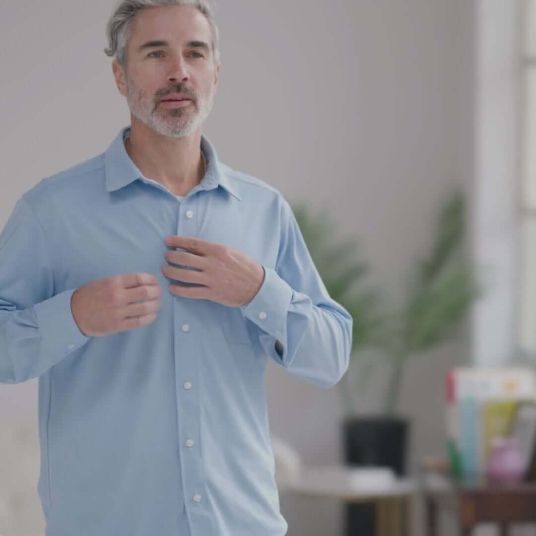 Man wearing a Carolina Blue MagnaReady long sleeve shirt with magnetic buttons, demonstrating comfort and ease of wear.