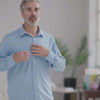 Man wearing a Carolina Blue MagnaReady long sleeve shirt with magnetic buttons, demonstrating comfort and ease of wear.