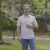 Adaptive Cooling Magnetic Front Short Sleeve Shirt in White Windowpane modeled outdoors by a man.