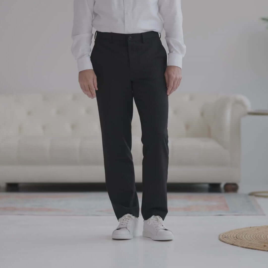 Man wearing Nautica® x MagnaReady® black adaptive dress pants with a white shirt and sneakers.