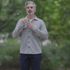 Stylish man wearing an adaptive grey flannel shirt outdoors, showcasing a versatile layering piece.