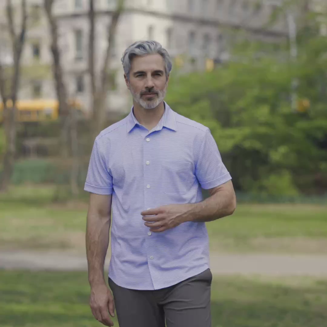 Adaptive Cooling Magnetic Front Short Sleeve Shirt in Blue Stripe being worn by a man outdoors.
