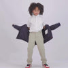 Child putting on a pink MagnaMini kids magnetic puffer coat, showcasing easy dressing and independence.