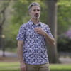 Adaptive Cooling Magnetic Front Short Sleeve Shirt in Blue Grey Palm worn outdoors by a man.
