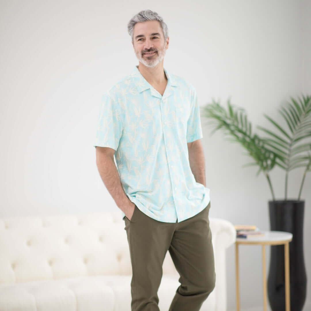 Man wearing a blue leaf short sleeve cooling shirt, designed for comfort and accessibility for those with limited mobility.