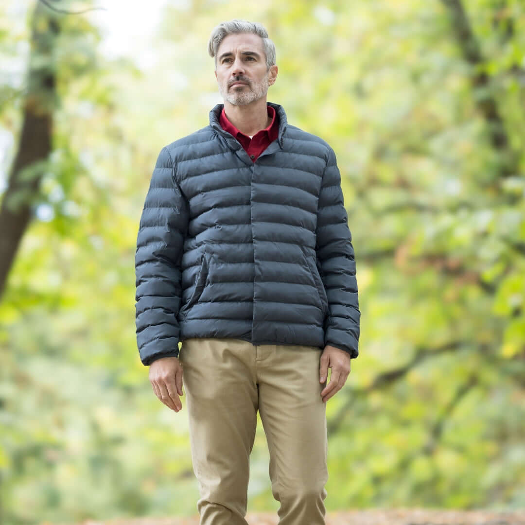 Man wearing Weatherproof x MagnaReady pewter puffer jacket outdoors, showcasing style and comfort.