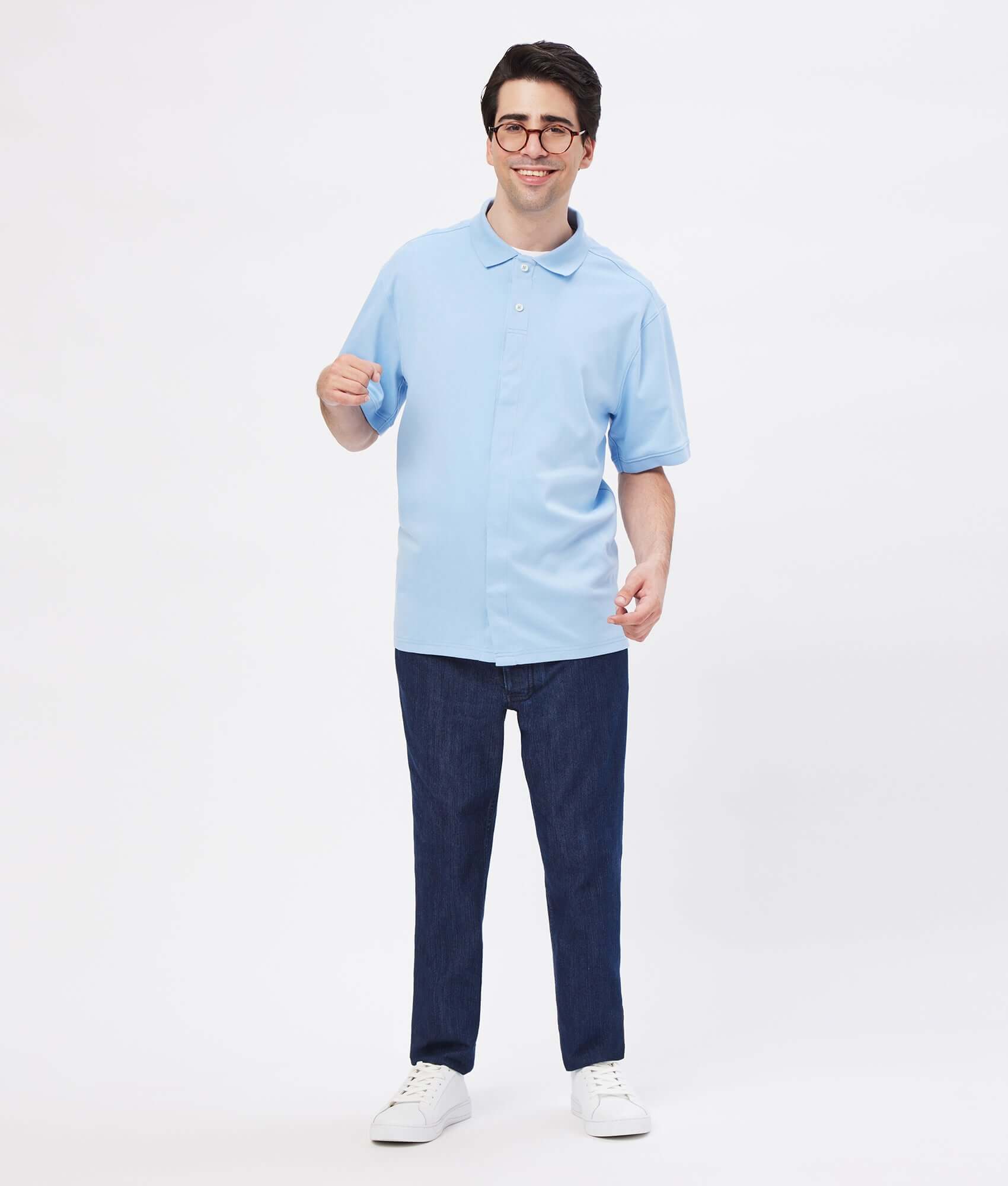 Model wearing a light blue solid interlock knit polo with magnetic closures and dark jeans.
